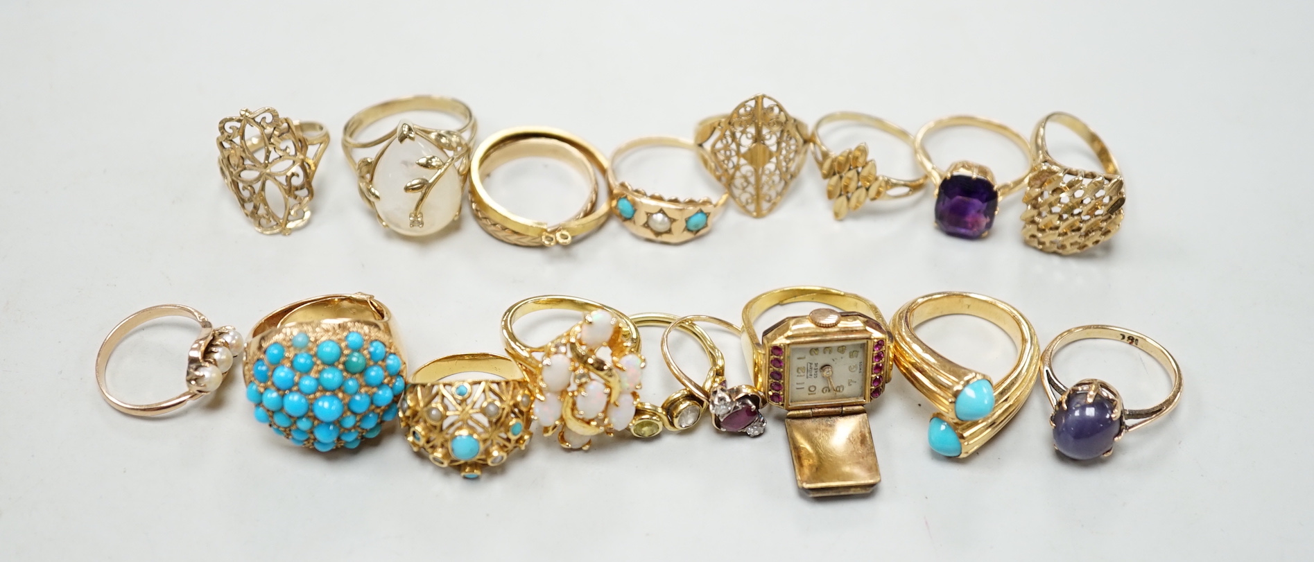 Three 18ct and gem set rings including star sapphire, turquoise and pearl and ruby and diamond three stone, five 9ct gold rings and a 9ct gold pendant mount and nine other rings including ring watch and Middle Eastern tu